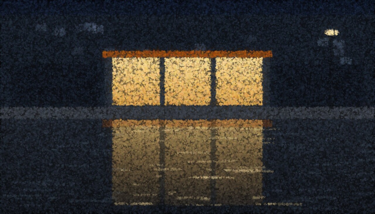 A wet street at dusk with lit shopfronts and their reflections doubled in the puddles below.