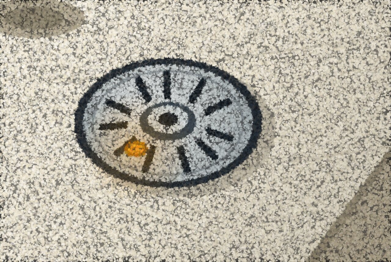 A round smoke alarm on a bright hallway ceiling seen from below, near a wall corner.