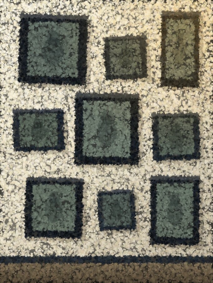 A wall of dark picture frames of different sizes hung slightly askew.
