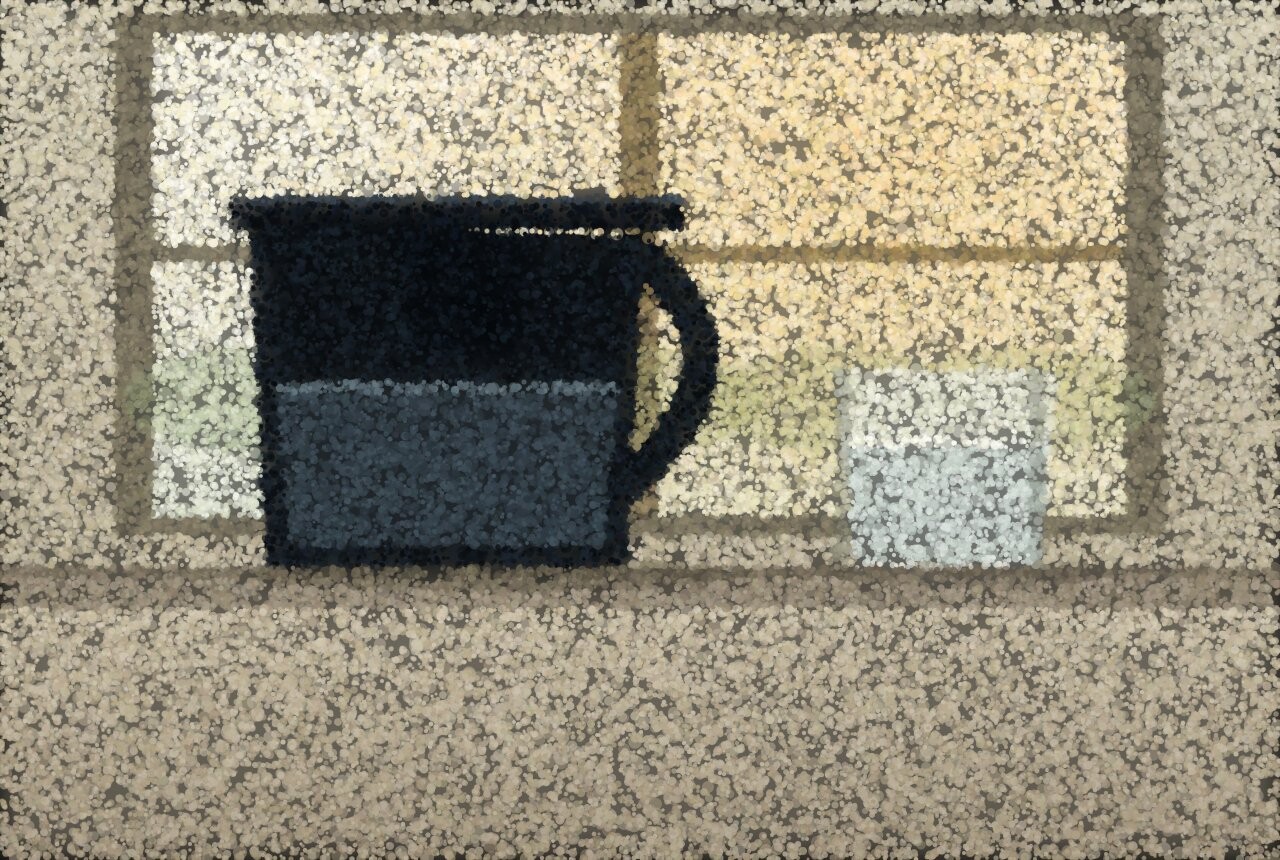 A filter jug standing on a bright kitchen windowsill beside a glass of water.