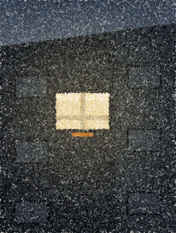 A dark building front at night with every window unlit except one, which glows warmly.