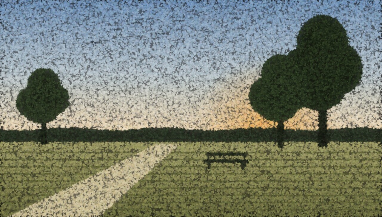 A field at dusk with a hedgerow, two dark trees and an empty bench beside a path.