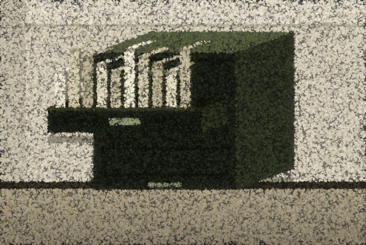 A dark filing cabinet against a light wall with one drawer pulled out, pale files standing up inside it.