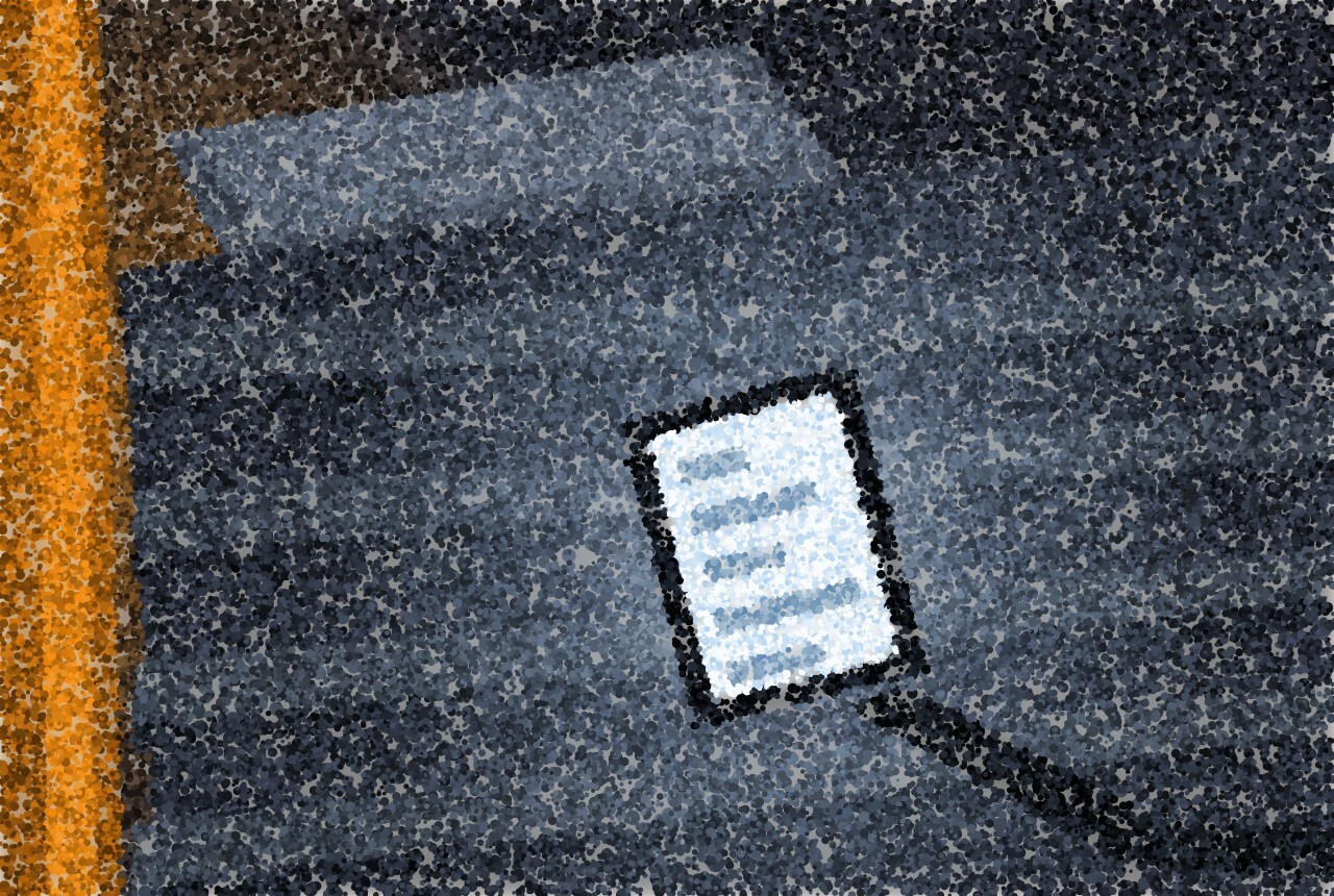 A phone lying face up on a dark duvet, its screen the only light in the room, a strip of warm light from a door left ajar.
