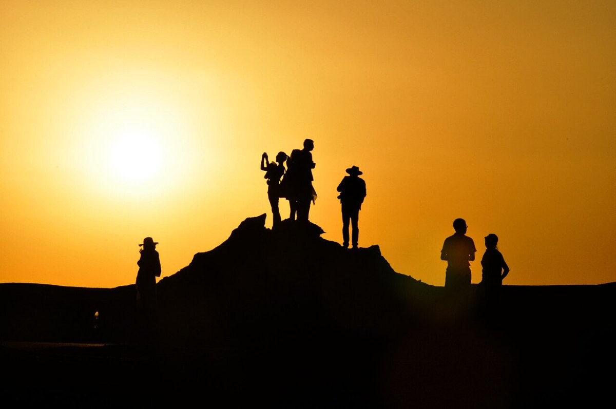 Silhouettes of a group of people at sunset