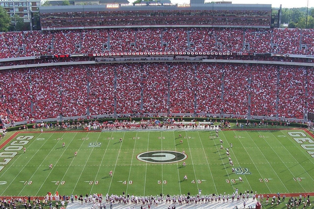 A football game kickoff in a stadium