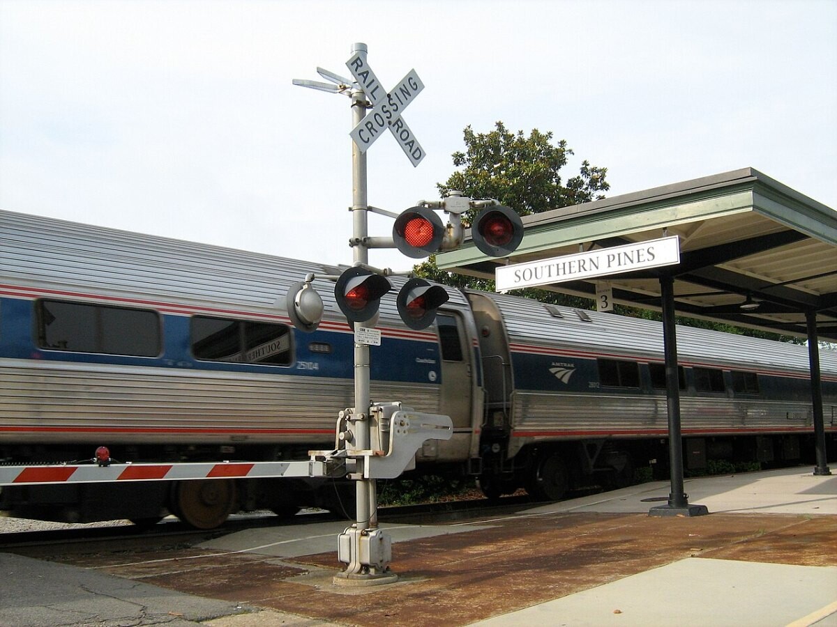 An Amtrak train at a level crossing