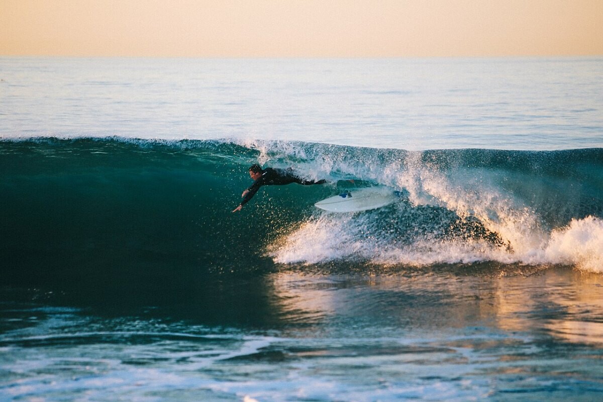 A surfer riding a wave at Newport Beach, California