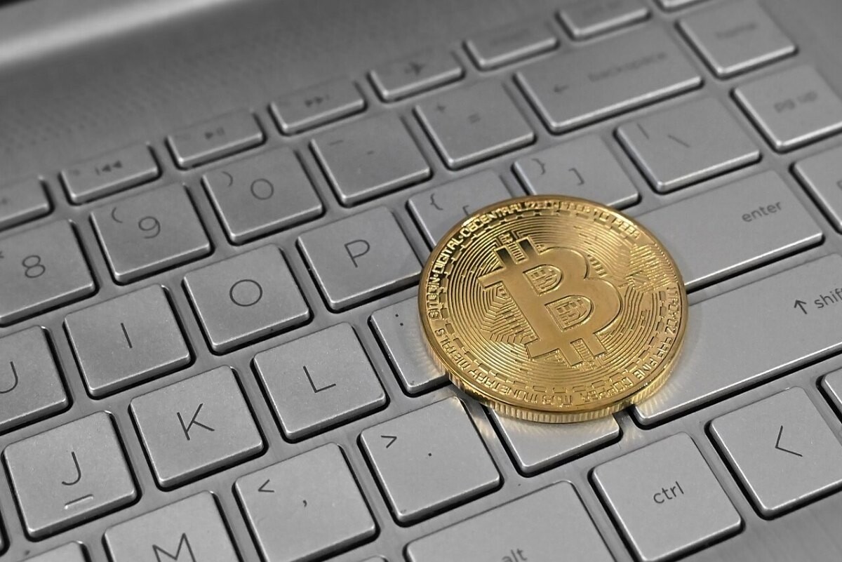 A bitcoin token on a laptop keyboard