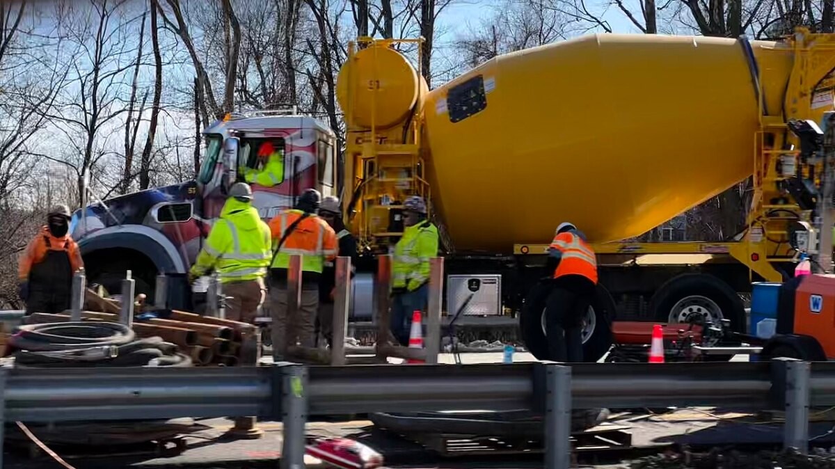 Repair crews with a concrete truck at a sinkhole on Interstate 80 in Wharton, New Jersey
