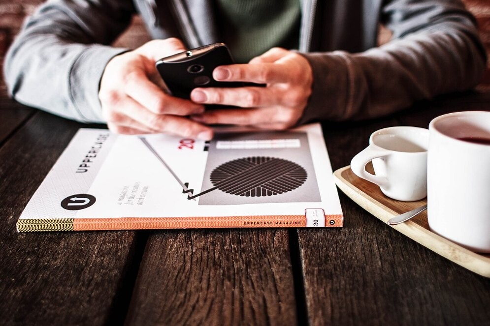 File photo of a person using a smartphone at a table
