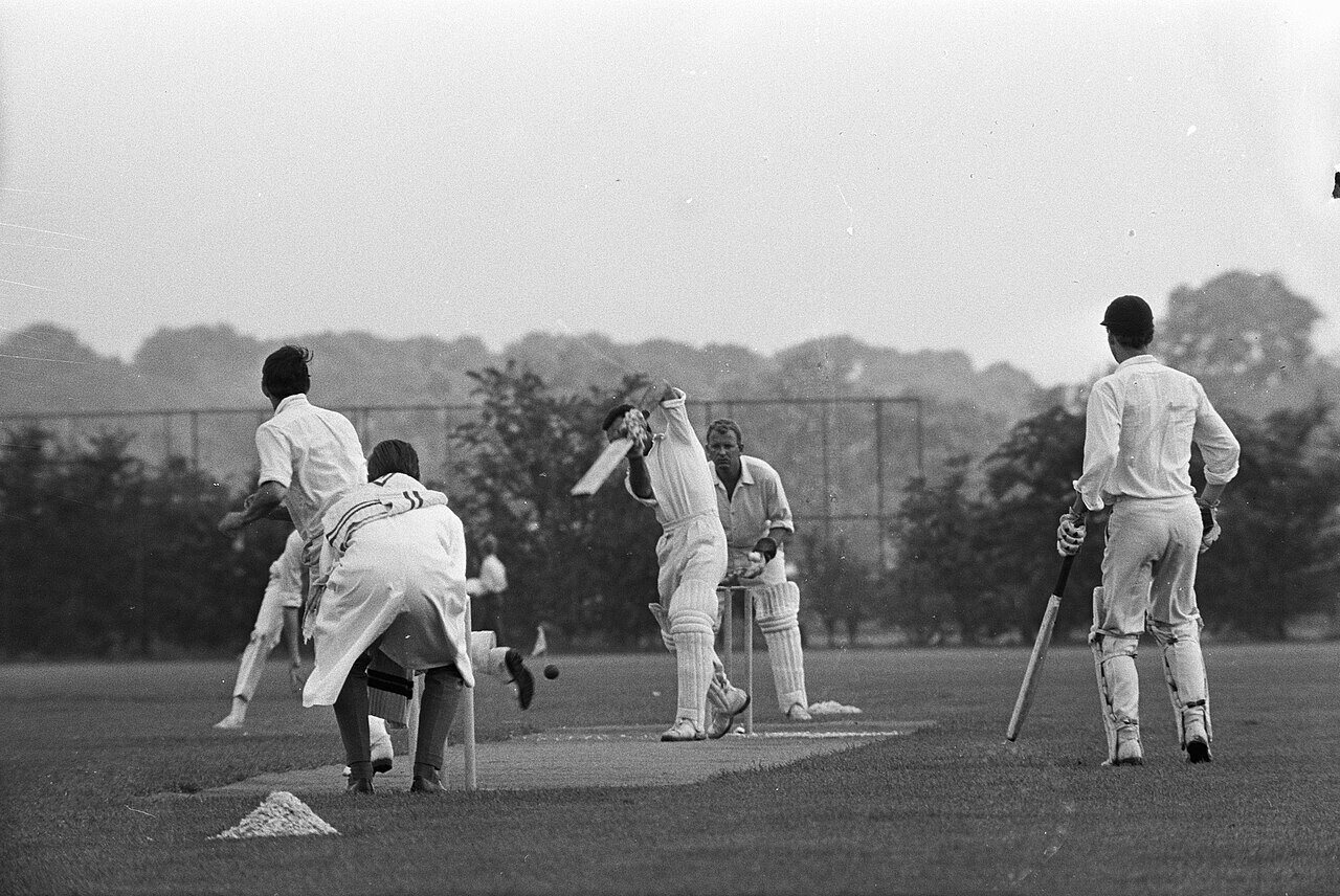 A club cricket match seen from beyond the boundary