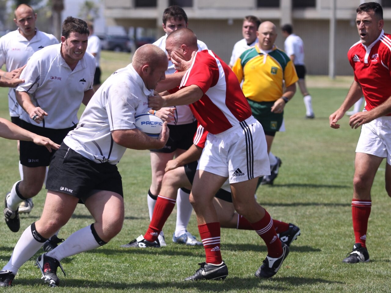 A rugby player attempting a tackle on a ball carrier during a match