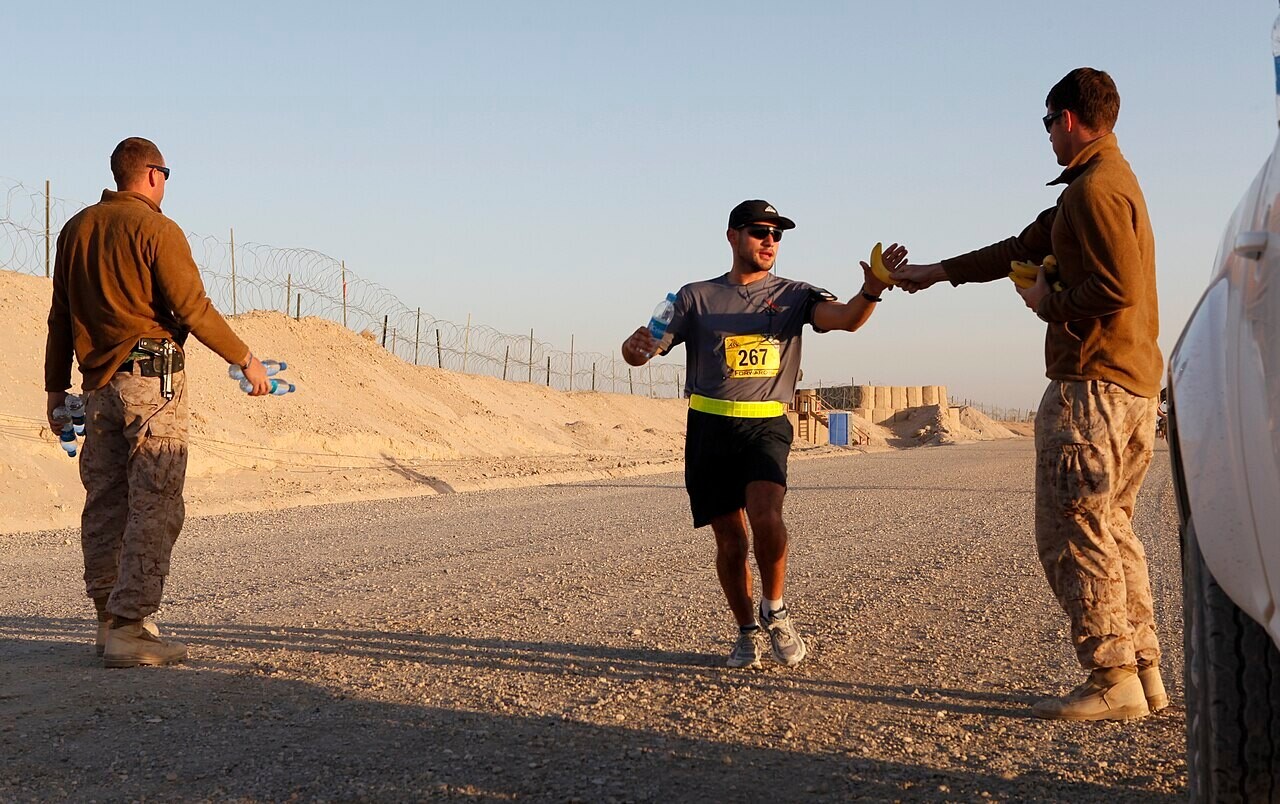 Volunteers handing out cups of water to runners during a marathon