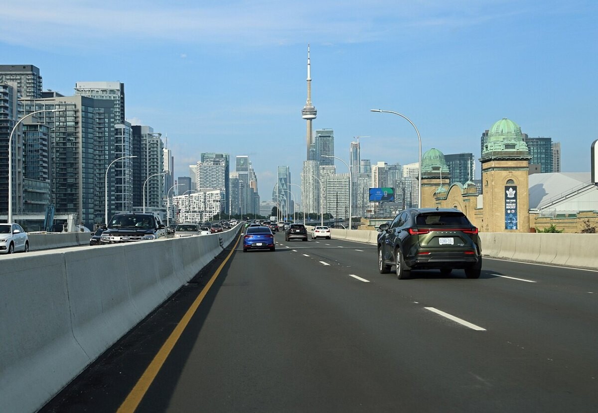 Eastbound traffic on an elevated expressway with the Toronto skyline ahead
