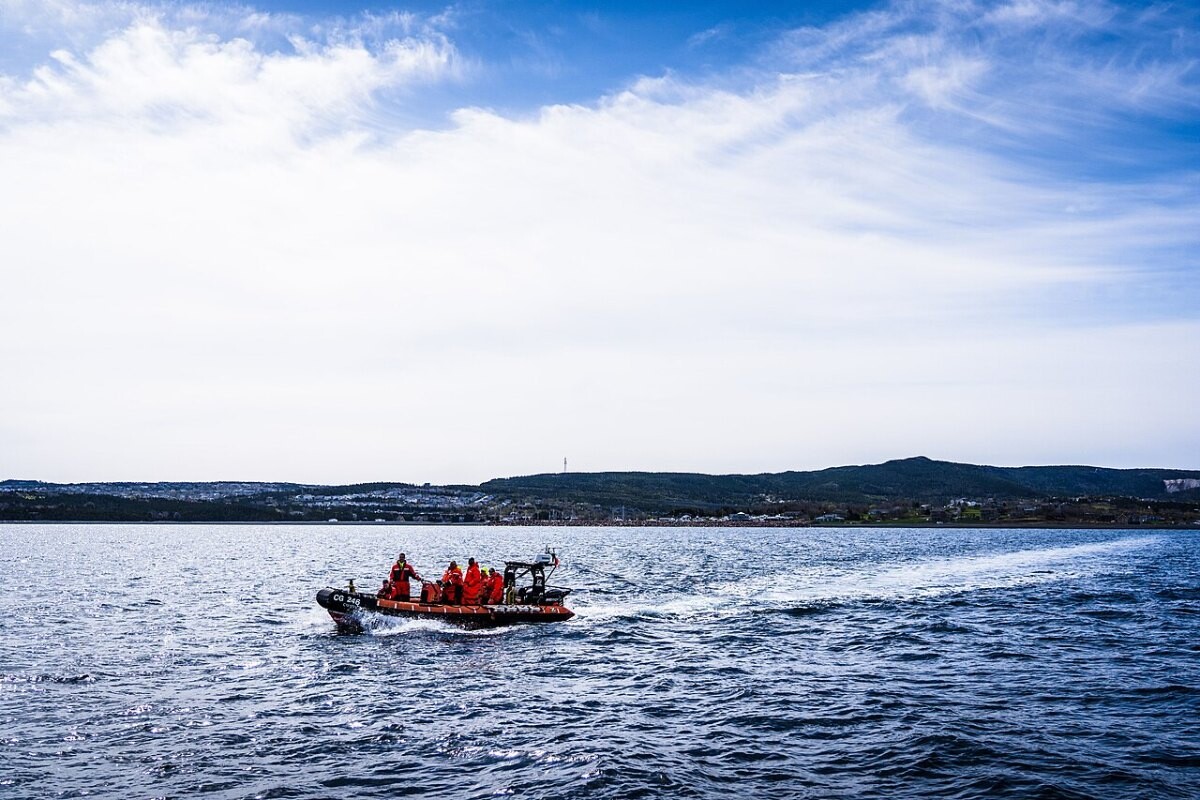 Canadian Coast Guard crew in survival suits aboard a rescue boat