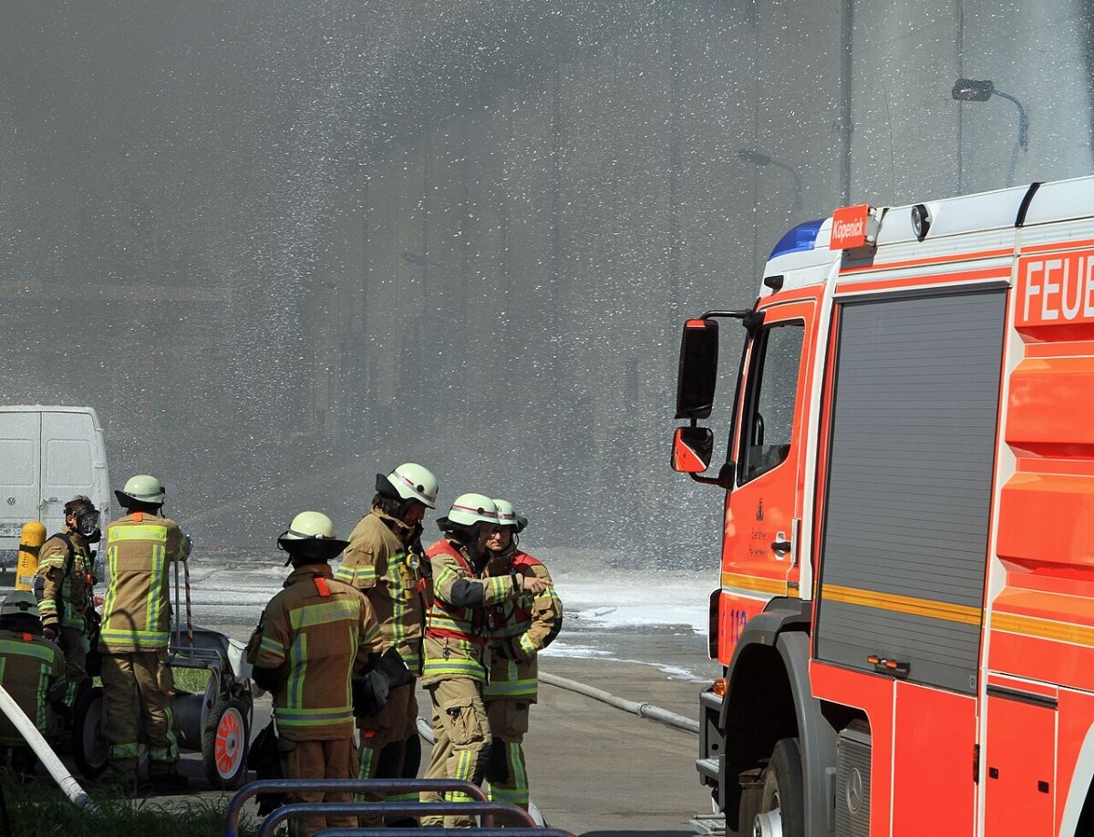 Dark smoke rising from a large fire at a market hall complex in Berlin