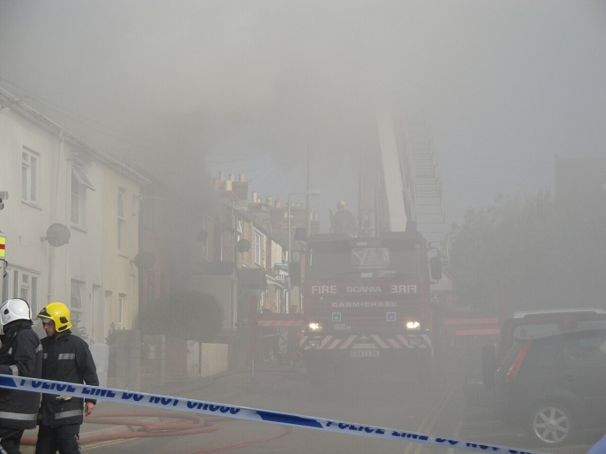 Firefighters and a fire engine at a smoke-filled house fire in Newport, Wales