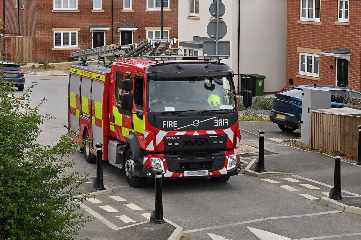Red fire engine of North Yorkshire Fire and Rescue Service parked in a village street