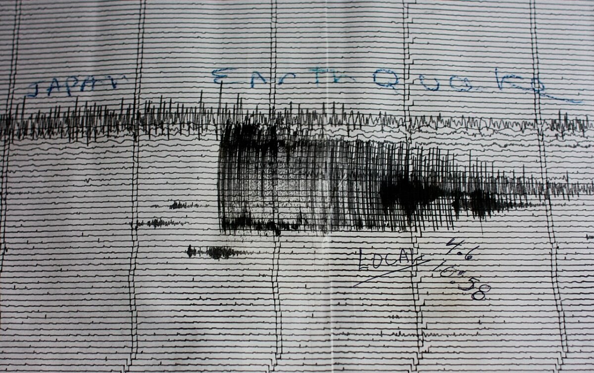 A paper seismogram covered in dense wavy lines