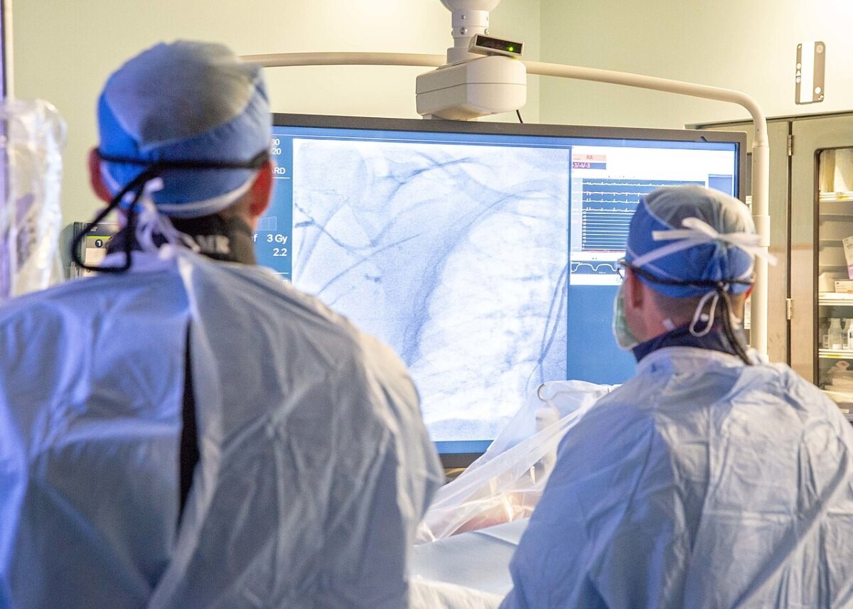 Cardiologists performing a catheter procedure in a cardiac lab