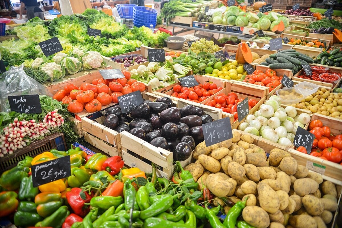 A market stall piled with fresh vegetables