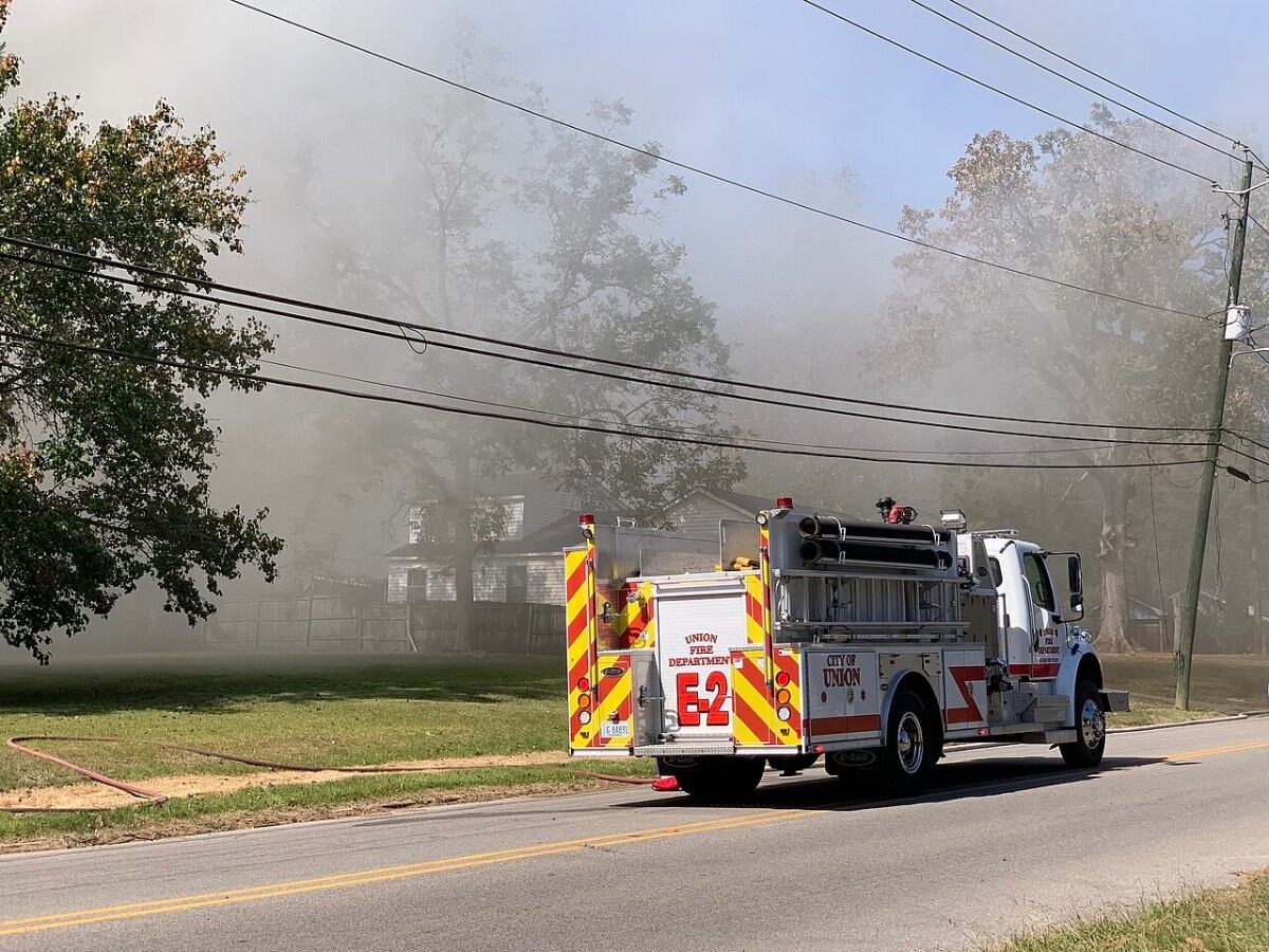 Fire engine parked outside a smoke-filled house in Union, Mississippi