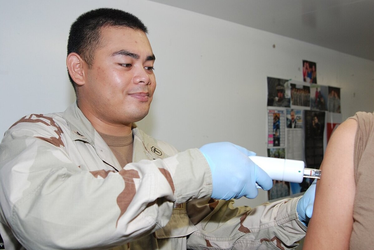 A Navy hospital corpsman giving a seasonal flu vaccination