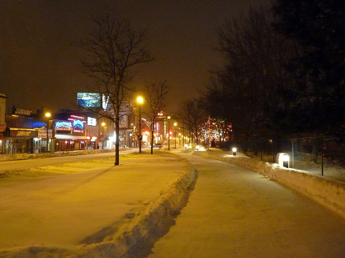 An icy, snow-covered pavement at night