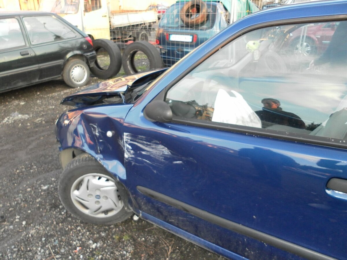 A small car with a crushed front end after a collision